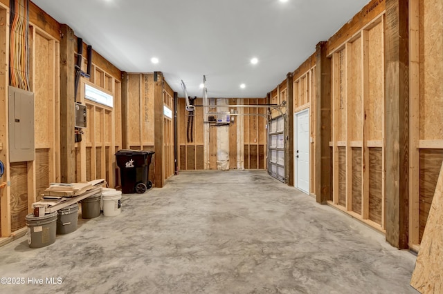 interior space with electric panel and concrete flooring