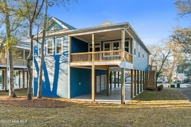 back of house with a patio, a carport, and driveway