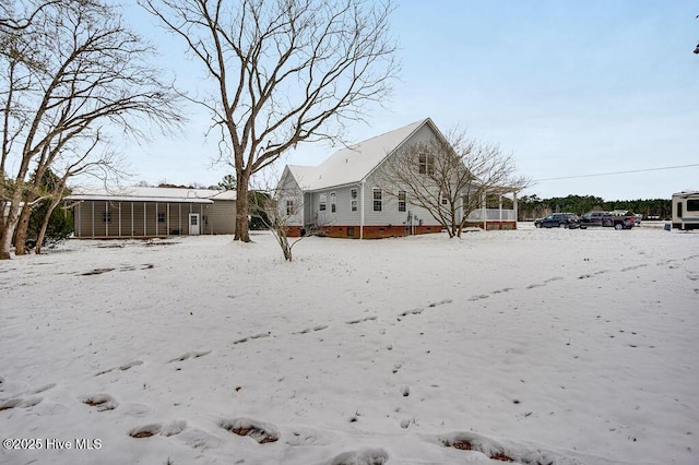 view of snow covered back of property