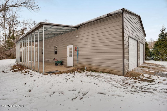 snow covered house with a garage