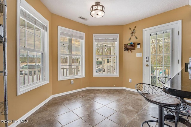 interior space with tile patterned floors and a healthy amount of sunlight