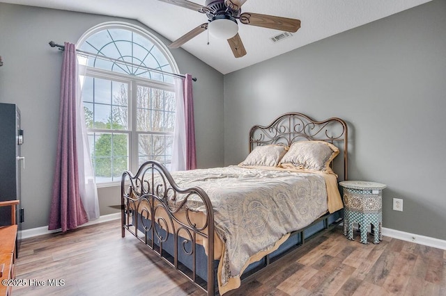 bedroom featuring lofted ceiling, hardwood / wood-style floors, and ceiling fan