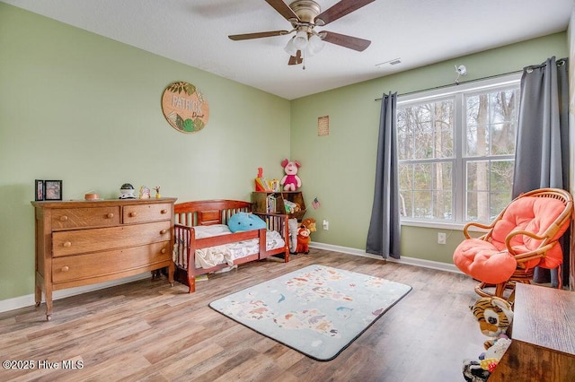 bedroom featuring light hardwood / wood-style floors and ceiling fan