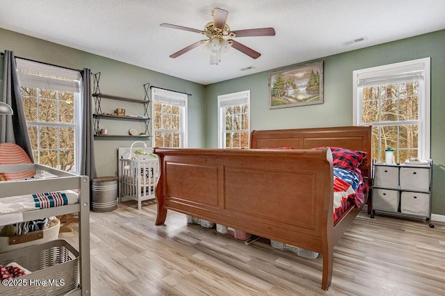 bedroom featuring ceiling fan and light wood-type flooring