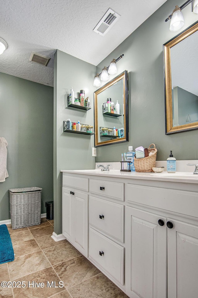 bathroom featuring vanity and a textured ceiling