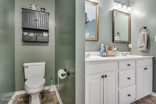 bathroom with vanity, tile patterned floors, and toilet