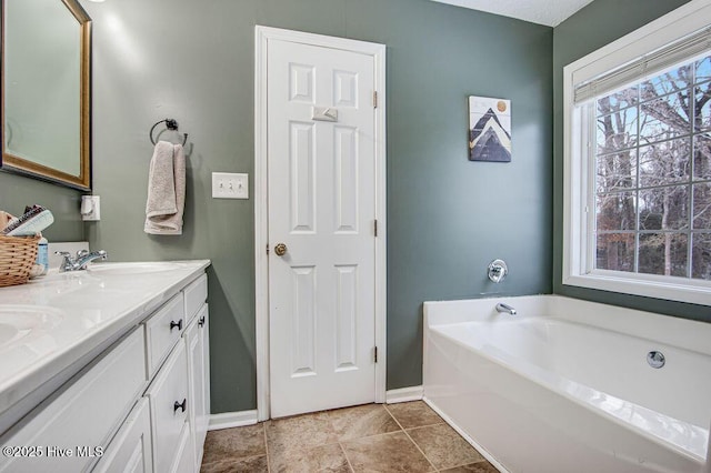 bathroom featuring vanity and a bathing tub