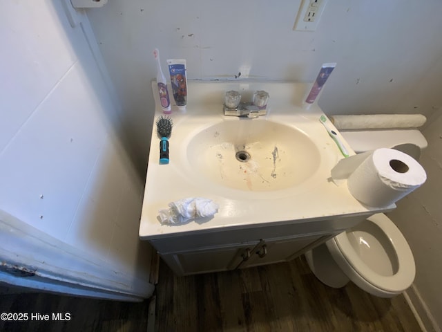 bathroom featuring sink, wood-type flooring, and toilet