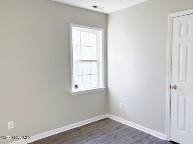 spare room with dark hardwood / wood-style flooring