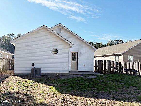 back of house with a yard and central AC unit