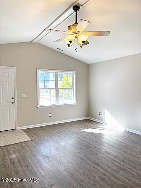 unfurnished room with wood-type flooring, lofted ceiling with beams, and ceiling fan