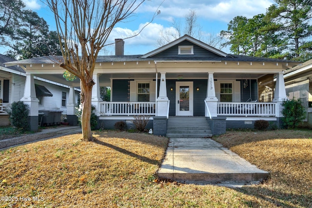 bungalow featuring a front yard and covered porch