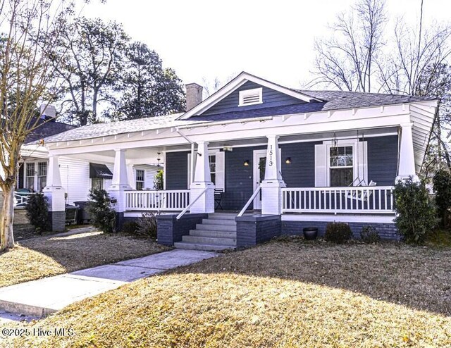 view of front of house with a shed and covered porch