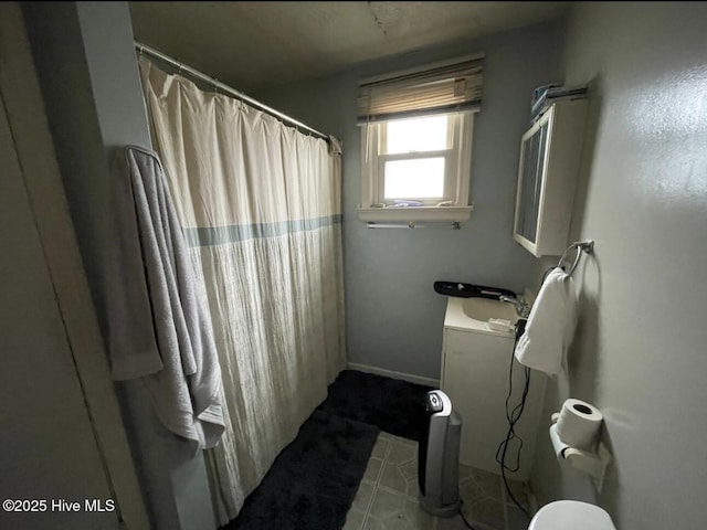 bathroom with walk in shower and vanity