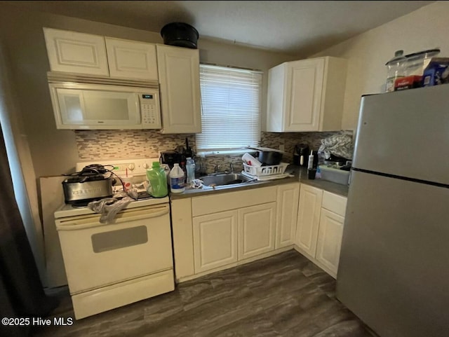 kitchen featuring white cabinetry, white appliances, sink, and backsplash