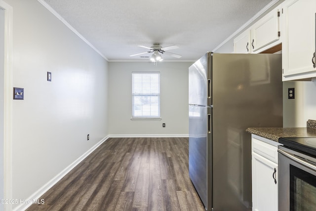 kitchen featuring appliances with stainless steel finishes, white cabinetry, ceiling fan, crown molding, and dark wood-type flooring