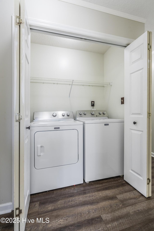 laundry area with dark wood-type flooring and independent washer and dryer