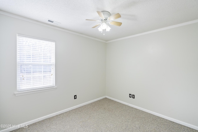 carpeted empty room with ceiling fan, ornamental molding, and a textured ceiling