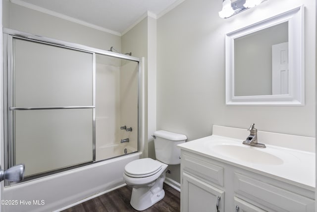 full bathroom with toilet, bath / shower combo with glass door, ornamental molding, vanity, and hardwood / wood-style flooring