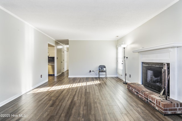 unfurnished living room with a fireplace, crown molding, and dark wood-type flooring