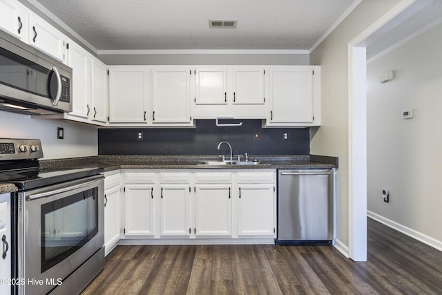 kitchen with appliances with stainless steel finishes, sink, and white cabinets