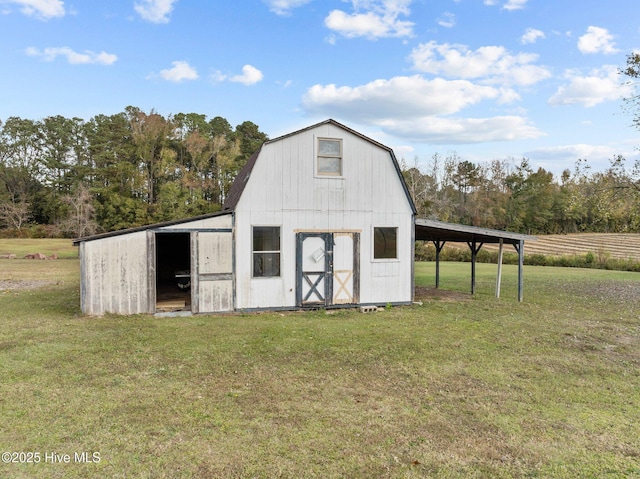 view of outbuilding featuring a rural view and a yard