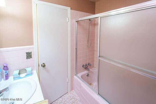 161 Willetts Dr, Boiling Spring Lakes, NC 28461 - bathroom featuring enclosed tub / shower combo, vanity, and tile walls