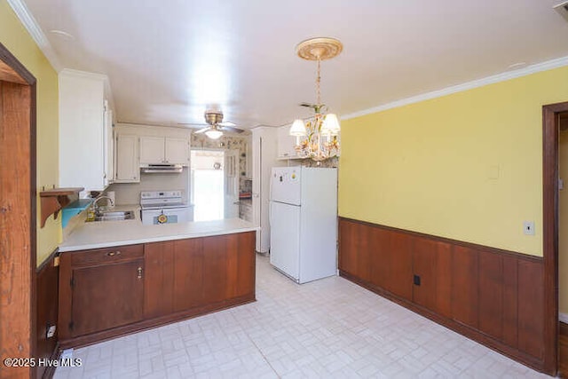 161 Willetts Dr, Boiling Spring Lakes, NC 28461 - kitchen featuring white appliances, a sink, light countertops, a peninsula, and extractor fan