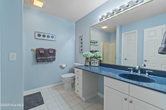 bathroom featuring tile patterned flooring, vanity, toilet, a shower with door, and a textured ceiling