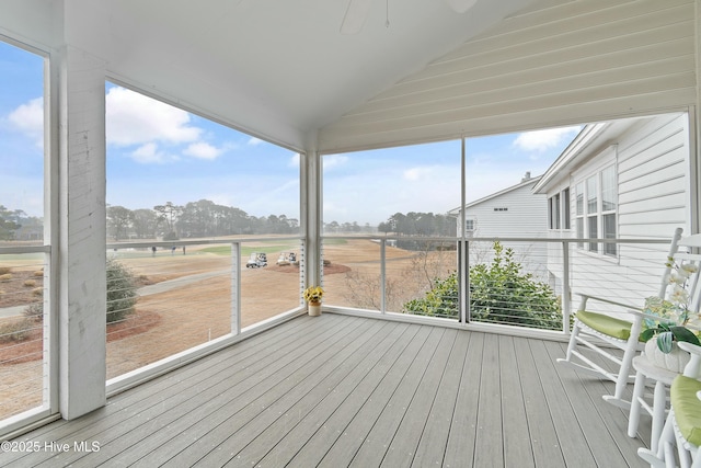 unfurnished sunroom with ceiling fan and lofted ceiling