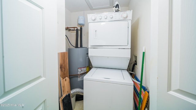 clothes washing area with stacked washing maching and dryer and electric water heater