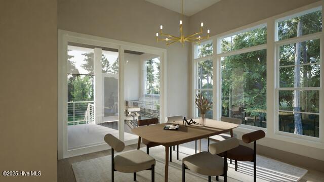 sunroom / solarium with an inviting chandelier