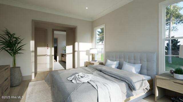 bedroom featuring ornamental molding, multiple windows, and light hardwood / wood-style flooring