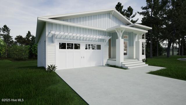 view of front of property featuring a garage and a front lawn