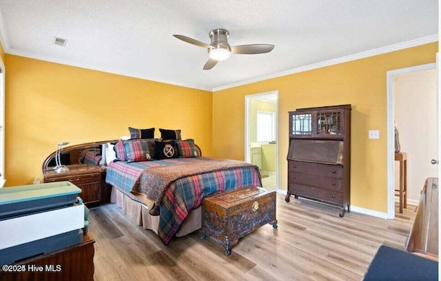 bedroom with ornamental molding, connected bathroom, and light hardwood / wood-style flooring