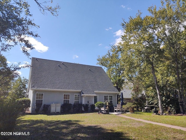 back of property featuring a lawn