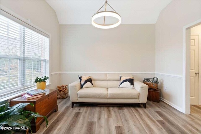 living area featuring light hardwood / wood-style flooring and vaulted ceiling