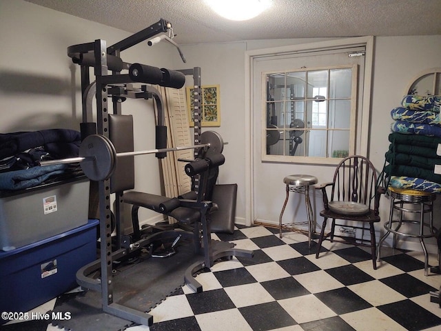 workout area with a textured ceiling