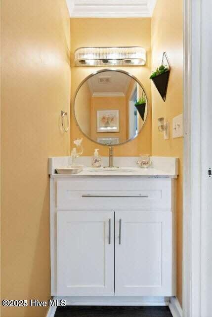 bathroom featuring crown molding and vanity