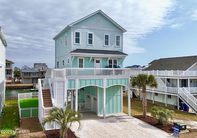 view of front of property with a carport and a water view