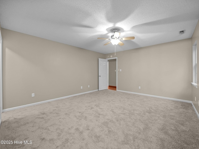 unfurnished room featuring ceiling fan, carpet flooring, and a textured ceiling