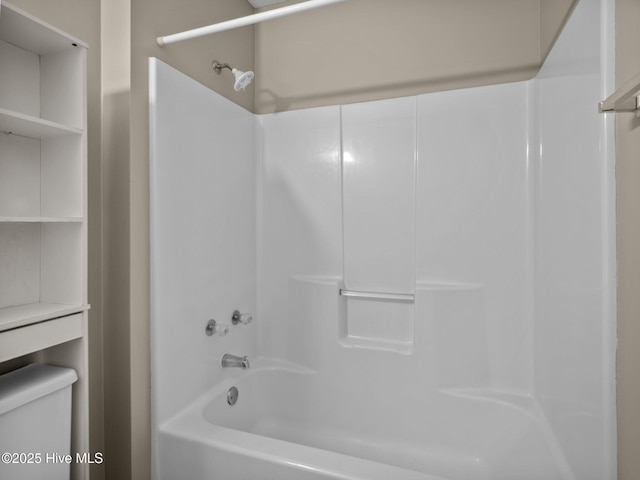 bathroom featuring shower / bathtub combination and toilet