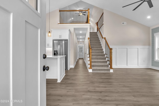 foyer with visible vents, stairs, and ceiling fan