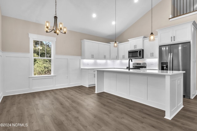 kitchen with white cabinets, light countertops, stainless steel appliances, and a chandelier