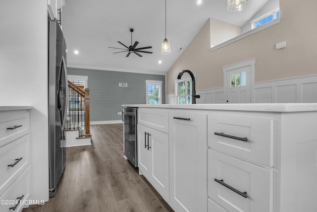 kitchen featuring a wainscoted wall, white cabinets, ceiling fan, dark wood finished floors, and lofted ceiling