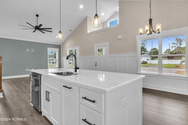 kitchen with a ceiling fan, vaulted ceiling, dark wood-style floors, white cabinets, and wainscoting
