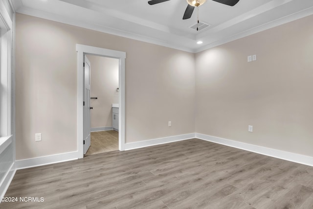 unfurnished bedroom featuring baseboards, a walk in closet, and light wood-type flooring