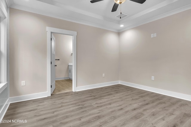 empty room featuring visible vents, baseboards, wood finished floors, and a ceiling fan