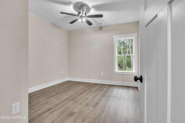 bathroom with baseboards, double vanity, and a sink