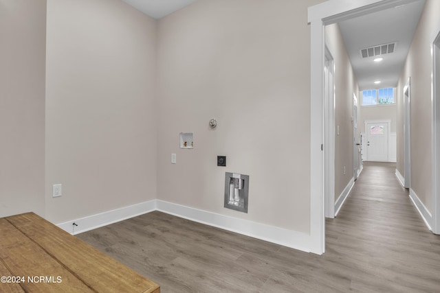 laundry area with hookup for a washing machine, hookup for a gas dryer, wood finished floors, and visible vents